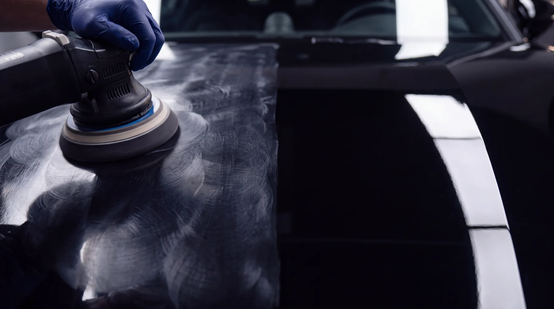 Half the bonnet corrected to a mirror, half still swirled — the split line under the light bar
